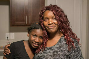 Theresa and her daughter smile for the camera.