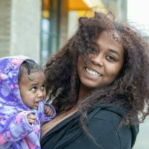 Image showing a successful Avivo program participant and her young daughter.