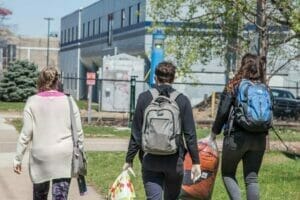 Avivo's Street Outreach Team, part of our Ending Homelessness Division, walks toward the Midtown Greenway to help residents of a small encampment.