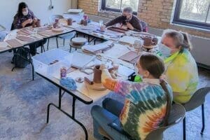 Avivo staff and program participants in Avivo's Community Support Program create ceramics as party of a weekly ceramics activity.