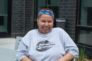 Toni smiles in front of the housing she was linked to by Avivo staff.
