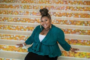 India, an employment success story at Avivo, smiles for the camera.