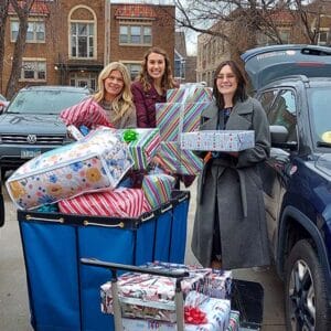 A group of staff from Northwestern Mutual Edina drop off holiday gifts for Avivo's Adopt-A-Family program in 2023.