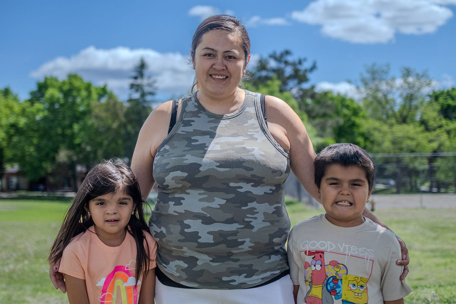 Megan, a successful participant in Avivo's programs, poses for a photo with her children.