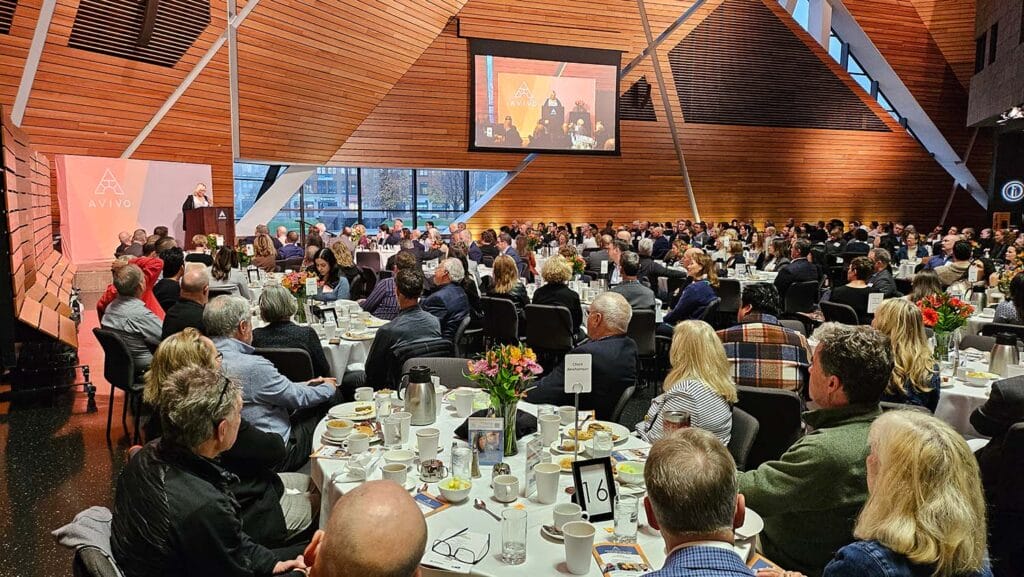 Candy, a former Avivo participant who's found success, speaks at Avivo's Achieving Dreams Breakfast.
