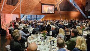 Candy, a former Avivo participant who's found success, speaks at Avivo's Achieving Dreams Breakfast.