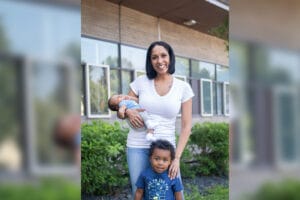 Tammy and her son pose for a photo, while Tammy holds her baby.