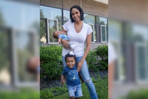 Tammy and her son pose for a photo, while Tammy holds her baby.