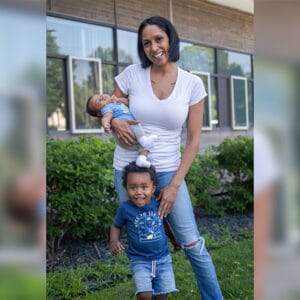 Tammy and her son pose for a photo, while Tammy holds her baby.
