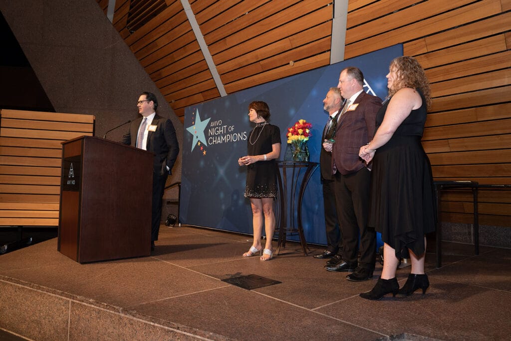 Leaders from Park State Bank accept an Avivo Champion award.