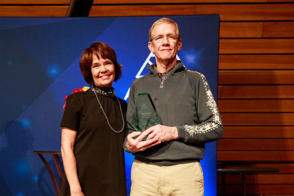 Tim Clark accepts an Avivo Champion award.